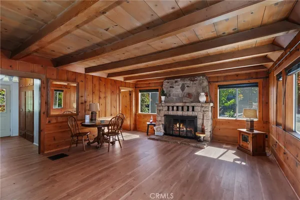 a living room with furniture fireplace and wooden floor