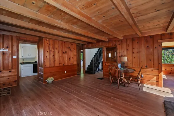 a view of a room with lots of wooden furniture