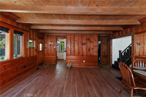 a view of a hallway with wooden floor and furniture