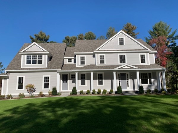 1 Greystone Road Dover, MA 02030 - Photo 1 of 3 a front view of a house with a garden and plants