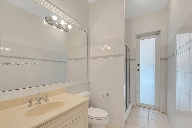 a bathroom with a sink toilet a mirror and shower