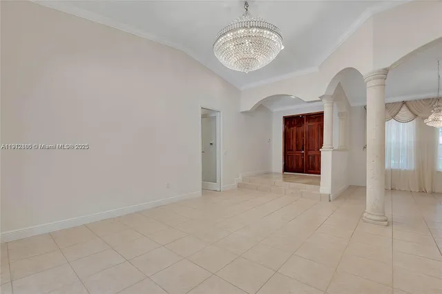 a view of an empty room with a chandelier