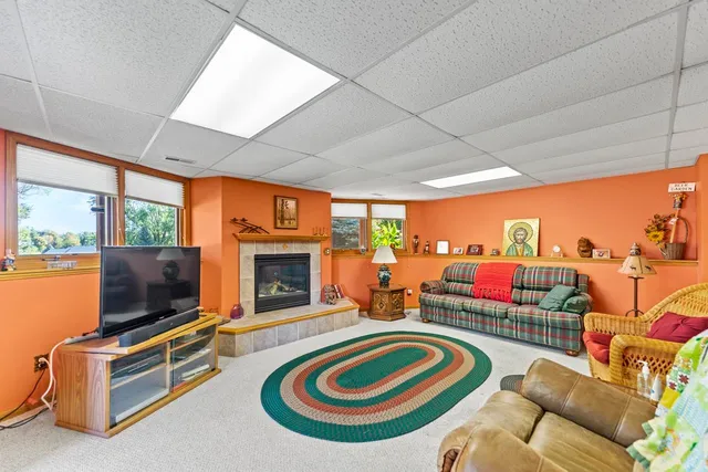 a living room with furniture a flat screen tv and a fireplace