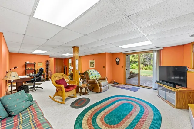 a bedroom with furniture and a flat screen tv
