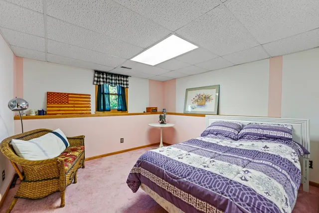 a bedroom with a bed and chair