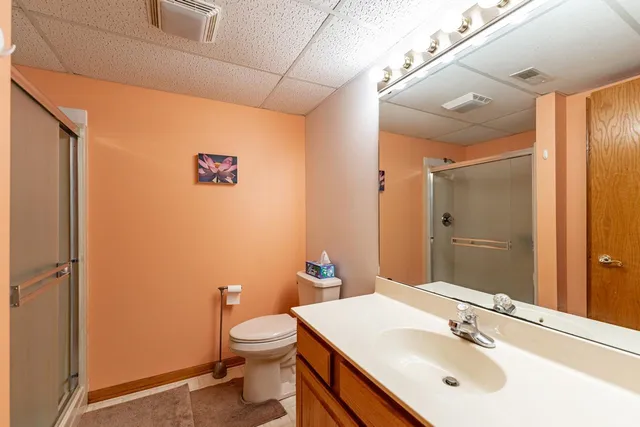 a bathroom with a sink mirror vanity and toilet