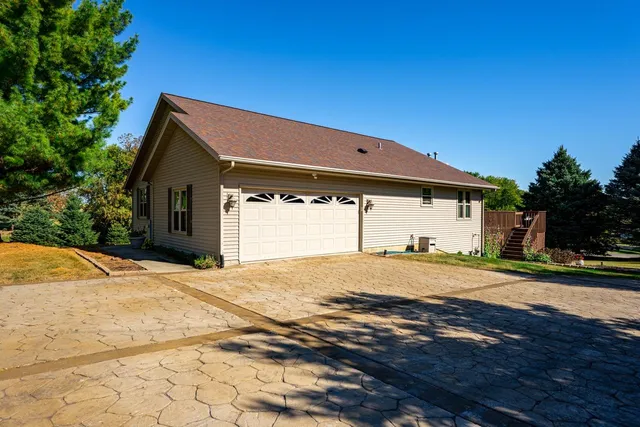 a view of a house with a yard and large tree