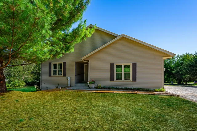 a view of front house with yard and green space