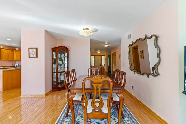 a view of a dining room with furniture and wooden floor