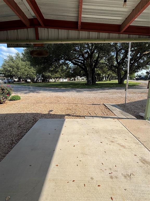 206 Holiday Rambler Drive Whitney, TX 76692 - Photo 5 of 28 a concrete patio, covered by port for additional space