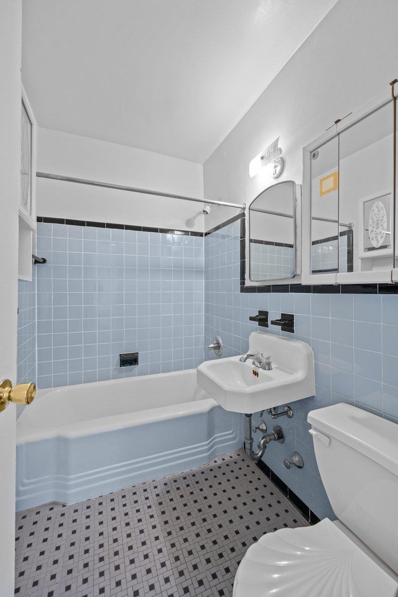 5500 Fieldston Road, Unit 8CC Bronx, NY 10471 - Photo 13 of 27 a bathroom with a sink toilet a mirror and shower
