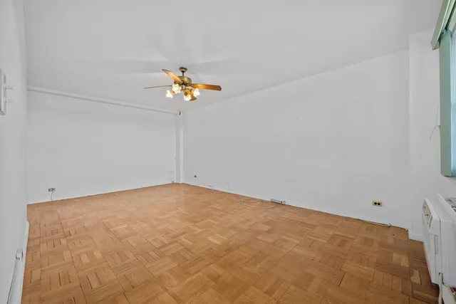 a view of a livingroom with a ceiling fan and window