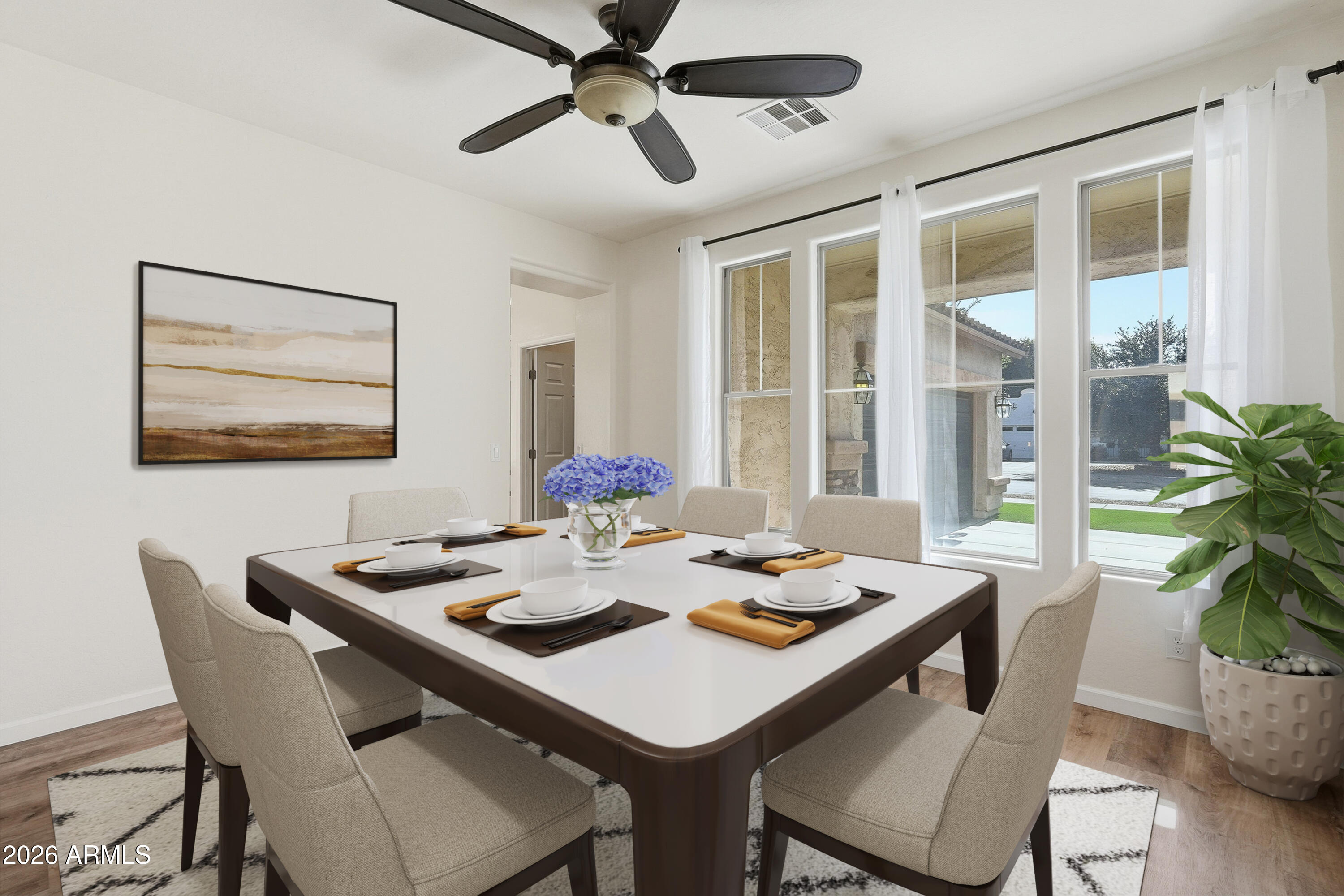 19760 East Mayberry Road Queen Creek, AZ 85142 - Photo 12 of 71 a dining room with furniture potted plants and wooden floor
