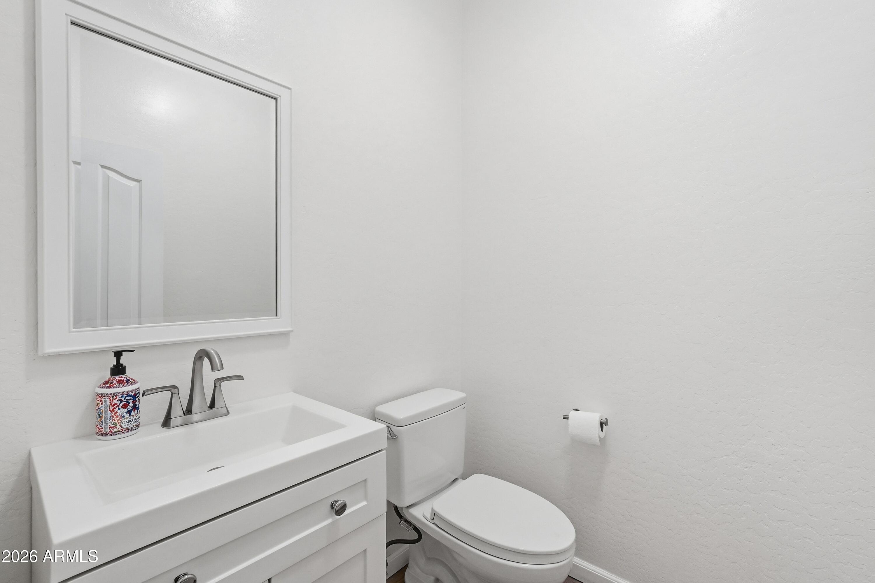 19760 East Mayberry Road Queen Creek, AZ 85142 - Photo 17 of 71 a bathroom with a sink a toilet and mirror