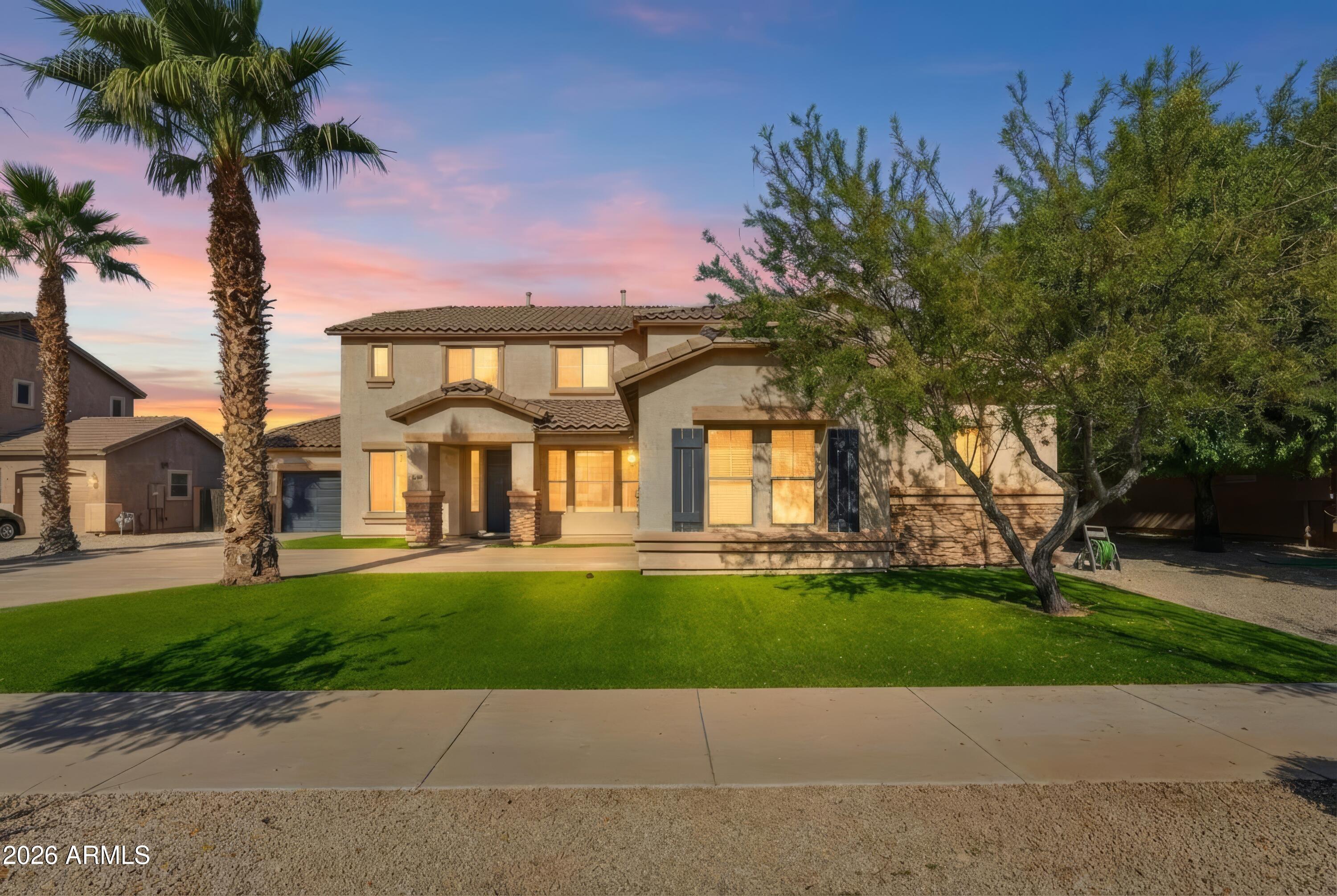 19760 East Mayberry Road Queen Creek, AZ 85142 - Photo 2 of 71 a front view of a house with a garden and a tree