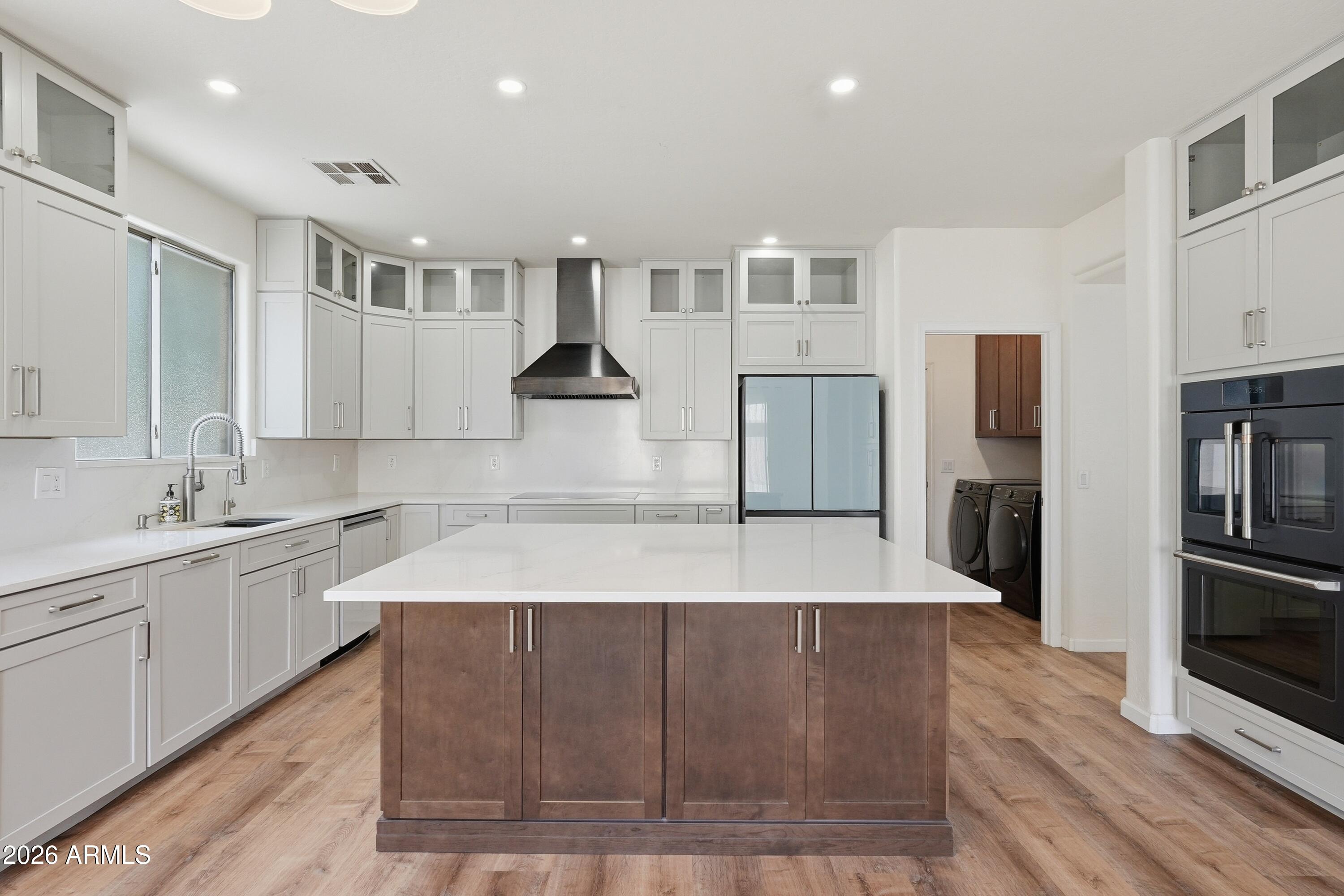 19760 East Mayberry Road Queen Creek, AZ 85142 - Photo 24 of 71 a large kitchen with stainless steel appliances kitchen island a large counter top and a sink