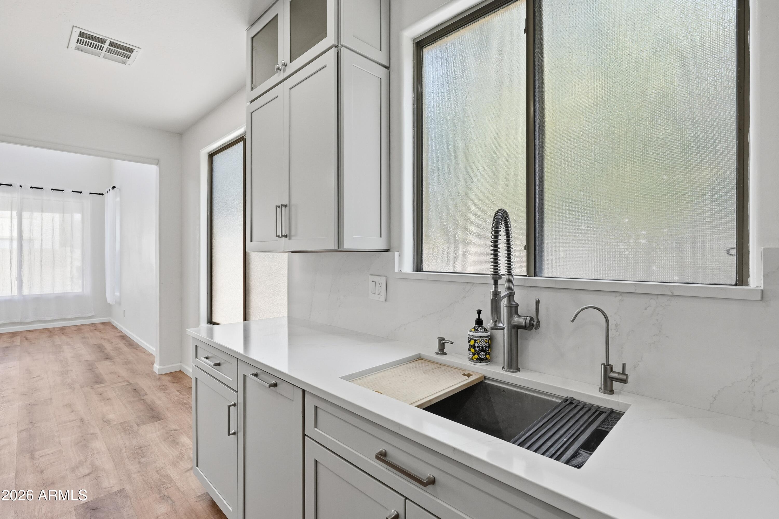 19760 East Mayberry Road Queen Creek, AZ 85142 - Photo 30 of 71 a kitchen with stainless steel appliances granite countertop a sink and a white cabinets