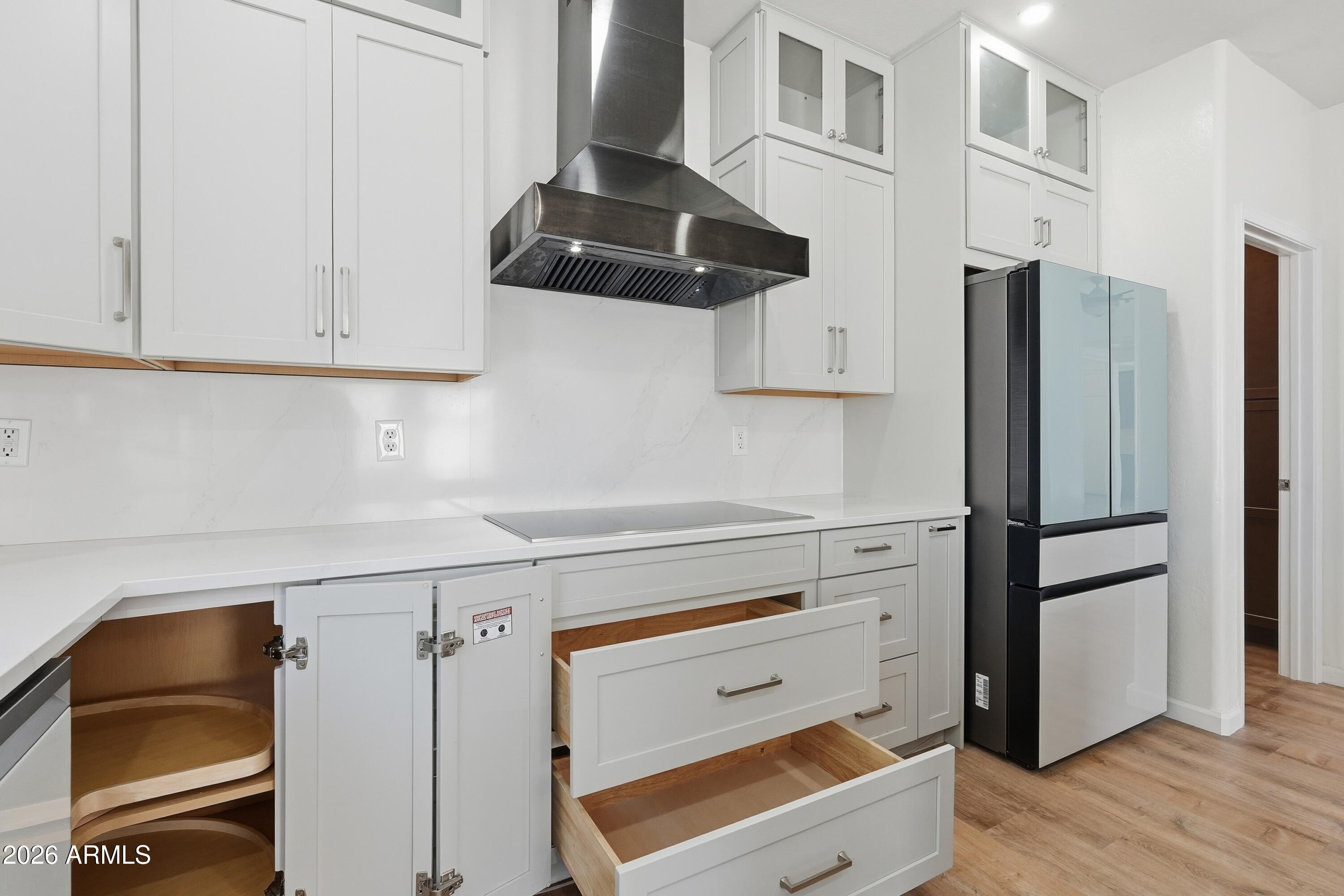 19760 East Mayberry Road Queen Creek, AZ 85142 - Photo 31 of 71 a kitchen with a refrigerator and cabinets