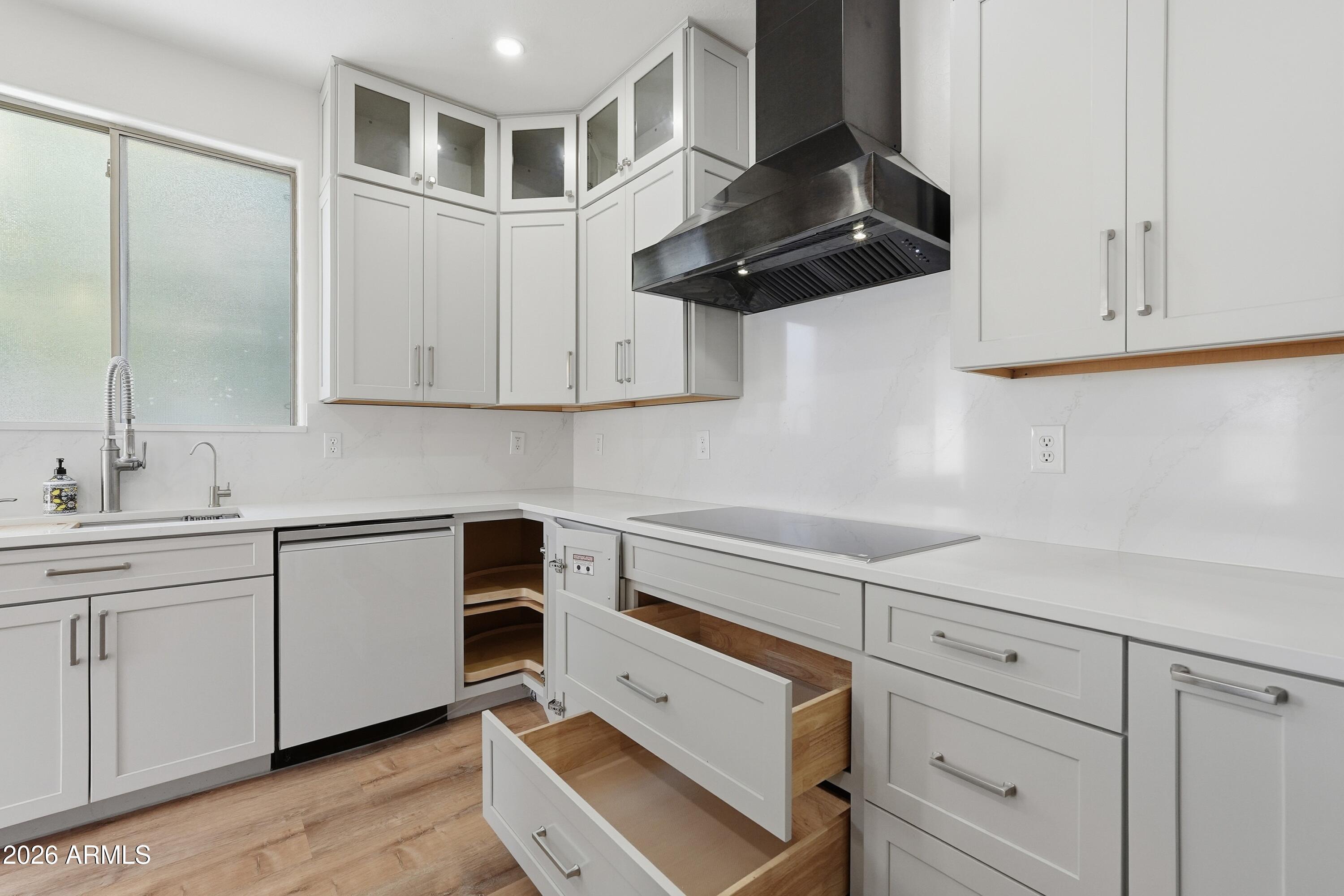19760 East Mayberry Road Queen Creek, AZ 85142 - Photo 32 of 71 a kitchen with white cabinets and white appliances