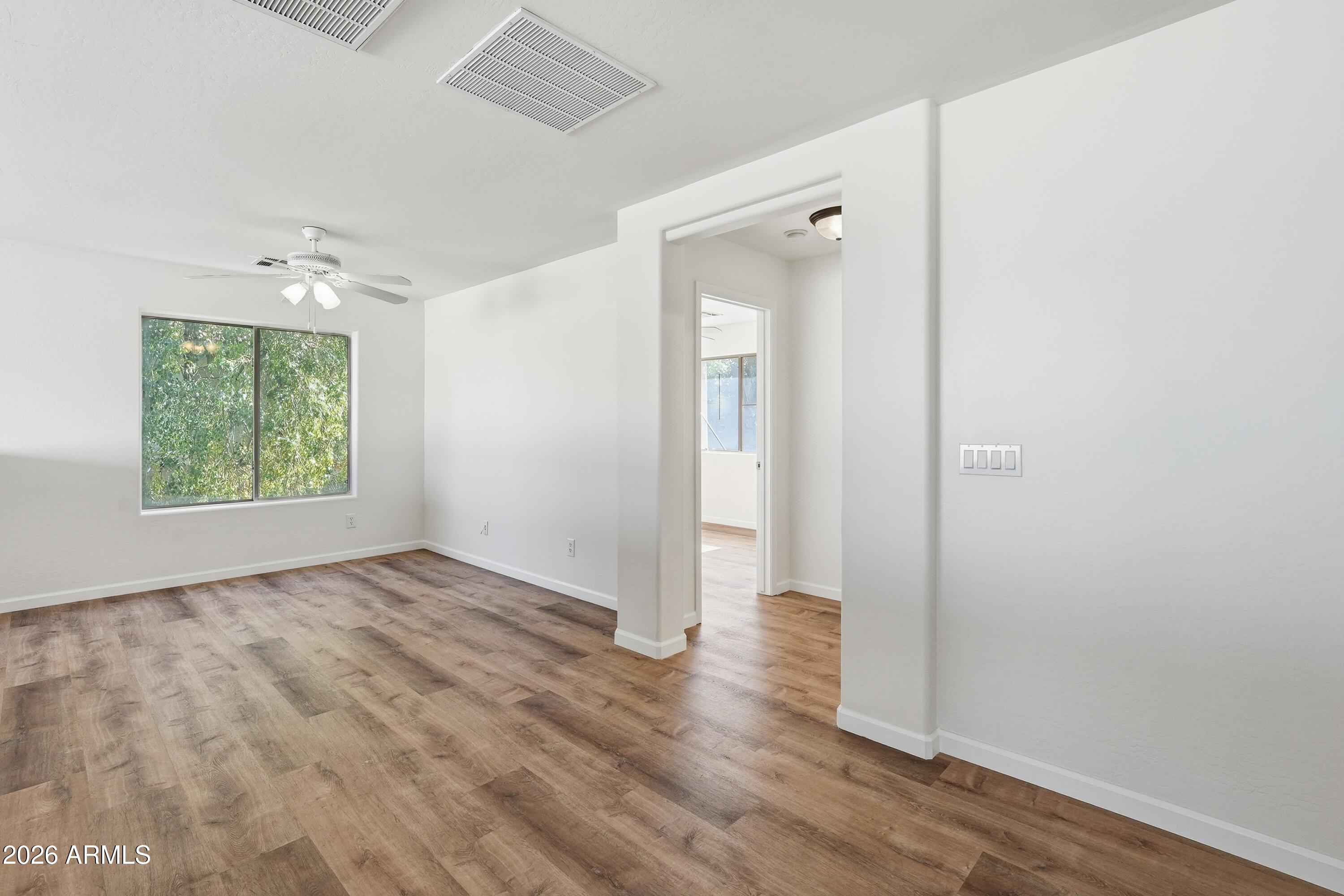 19760 East Mayberry Road Queen Creek, AZ 85142 - Photo 35 of 71 an empty room with wooden floor and a window