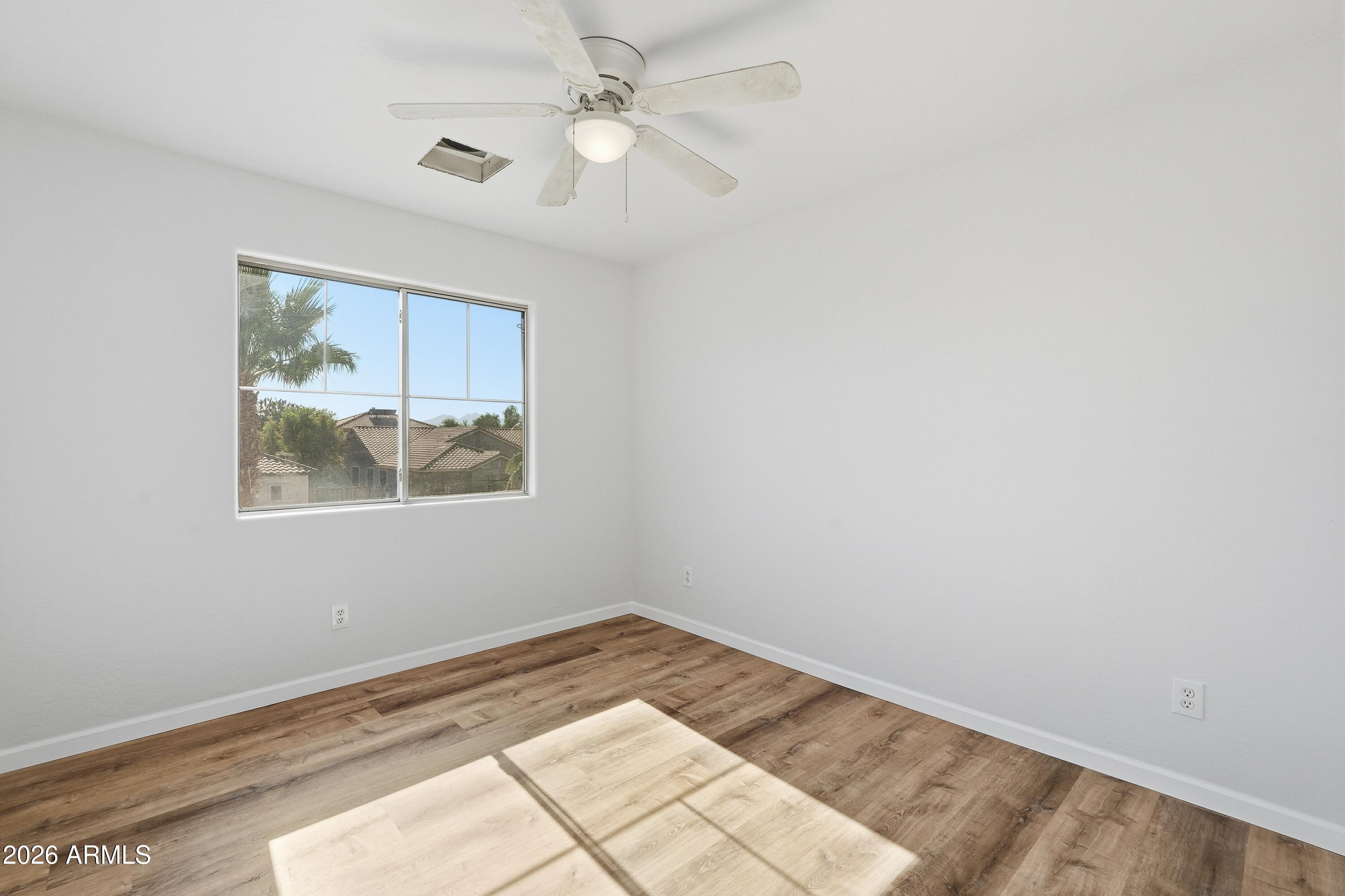 19760 East Mayberry Road Queen Creek, AZ 85142 - Photo 39 of 71 a view of a big room with wooden floor and a ceiling fan