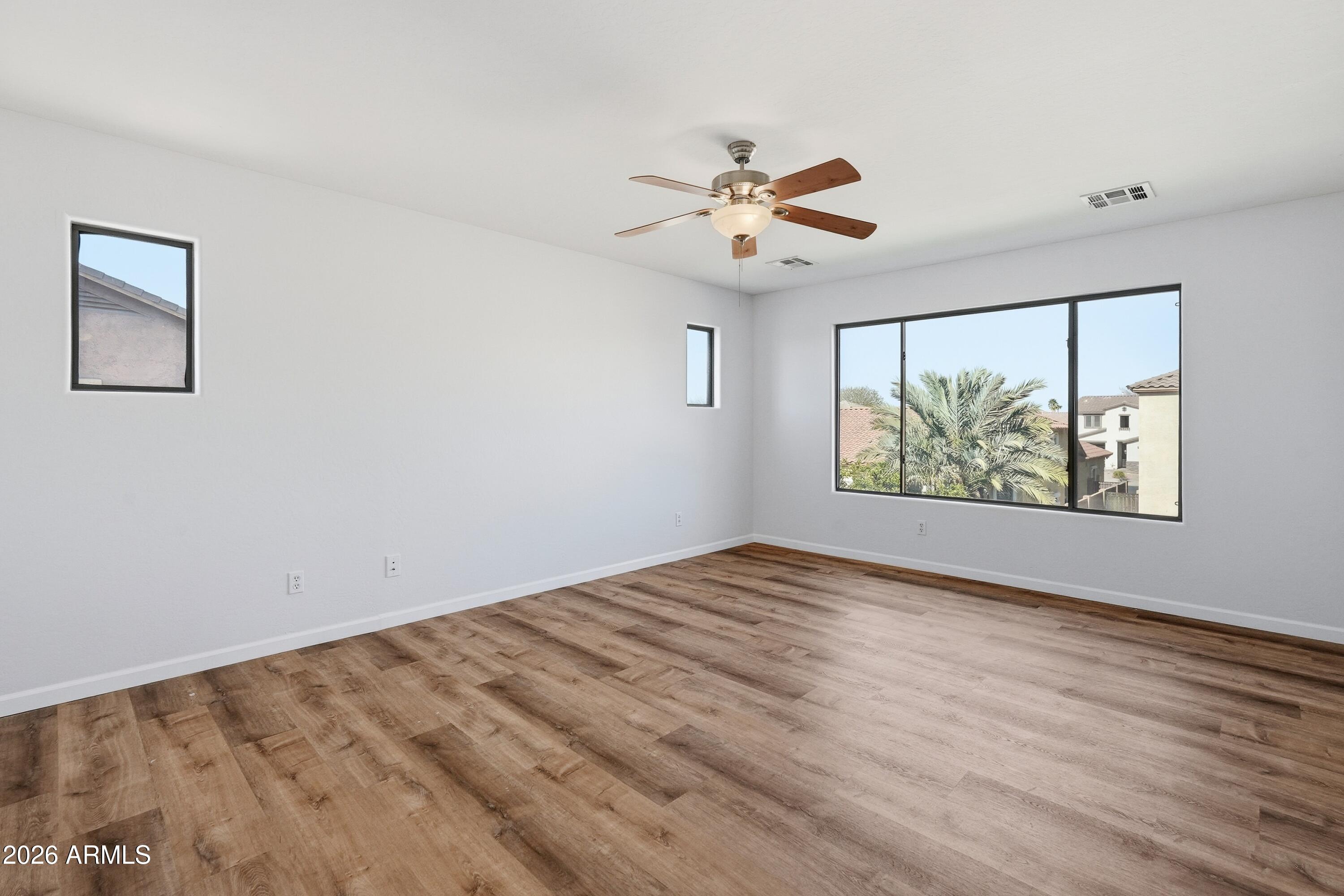19760 East Mayberry Road Queen Creek, AZ 85142 - Photo 48 of 71 a view of an empty room with window and wooden floor