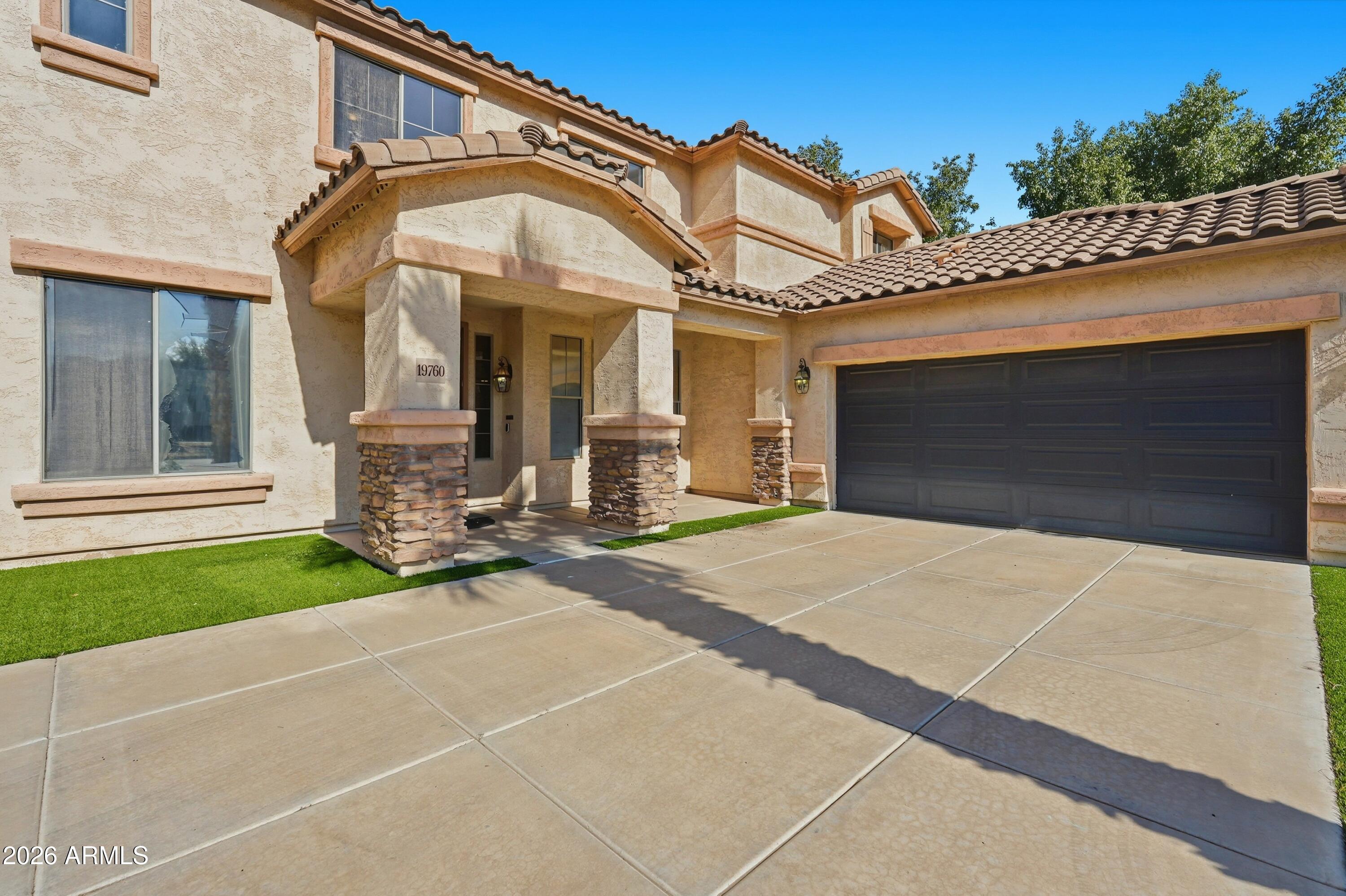 19760 East Mayberry Road Queen Creek, AZ 85142 - Photo 5 of 71 a front view of a house with a garden and entryway