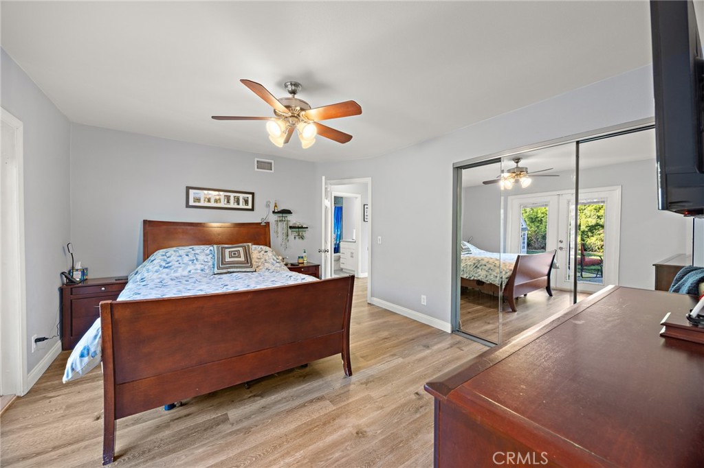 7548 Pepper Street Rancho Cucamonga, CA 91730 - Photo 12 of 24 a bed room with a bed and a chandelier