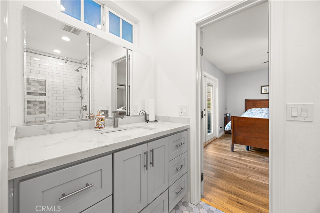 7548 Pepper Street Rancho Cucamonga, CA 91730 - Photo 13 of 24 a en suite bathroom with a double vanity sink and mirror