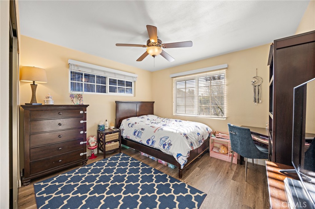 7548 Pepper Street Rancho Cucamonga, CA 91730 - Photo 14 of 24 a bedroom with a bed and wooden floor