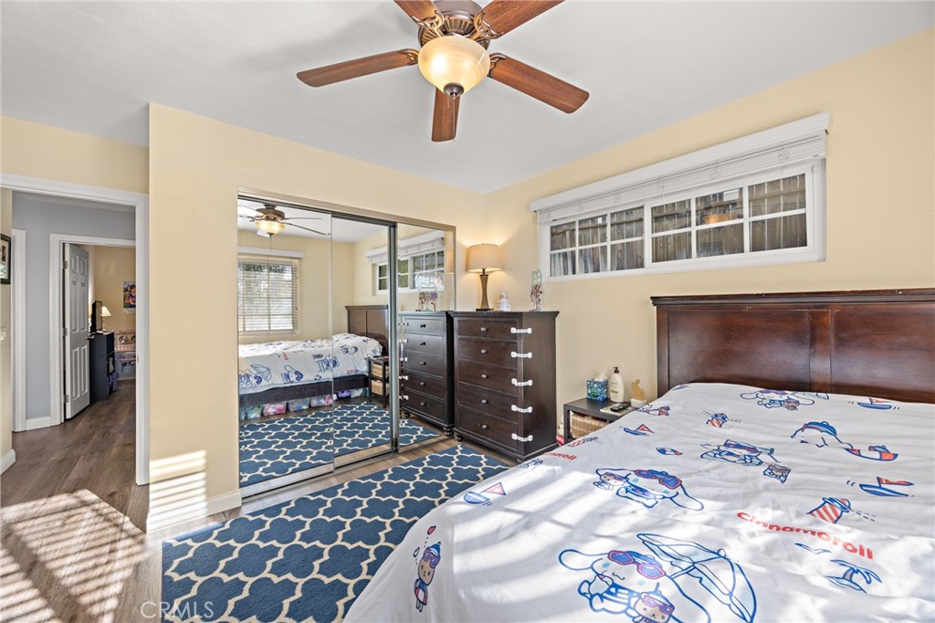 7548 Pepper Street Rancho Cucamonga, CA 91730 - Photo 15 of 24 a bedroom with a bed and a chandelier fan