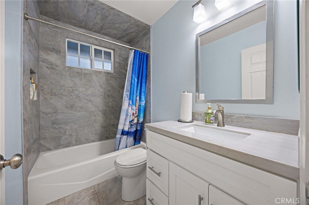 7548 Pepper Street Rancho Cucamonga, CA 91730 - Photo 17 of 24 a bathroom with a sink a toilet and a bathtub