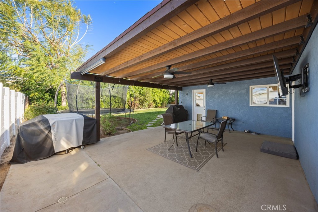 7548 Pepper Street Rancho Cucamonga, CA 91730 - Photo 19 of 24 a view of a patio with table and chairs and potted plants
