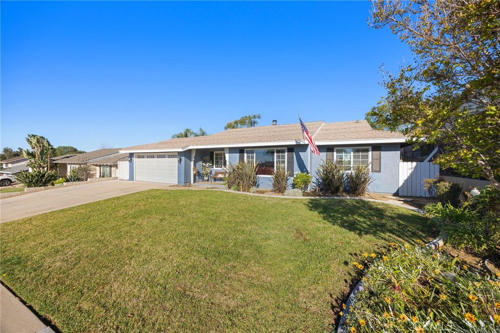 7548 Pepper Street Rancho Cucamonga, CA 91730 - Photo 4 of 24 a front view of a house with a garden