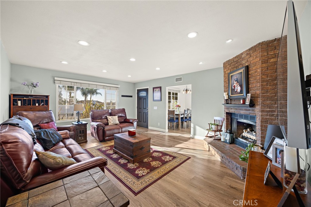 7548 Pepper Street Rancho Cucamonga, CA 91730 - Photo 7 of 24 a living room with furniture fireplace and a flat screen tv