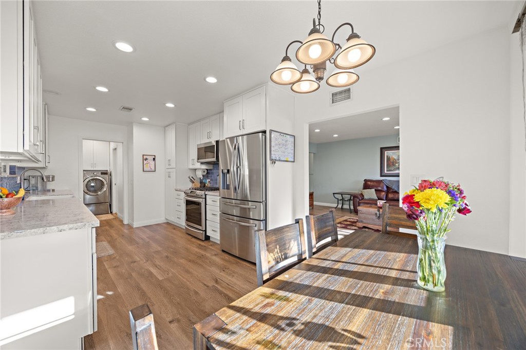 7548 Pepper Street Rancho Cucamonga, CA 91730 - Photo 8 of 24 a kitchen with stainless steel appliances granite countertop a sink refrigerator and microwave