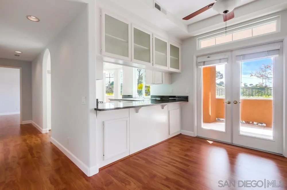 3525 Cameo Drive, Unit 92 Oceanside, CA 92056 - Photo 11 of 43 a kitchen with a refrigerator and wooden floor