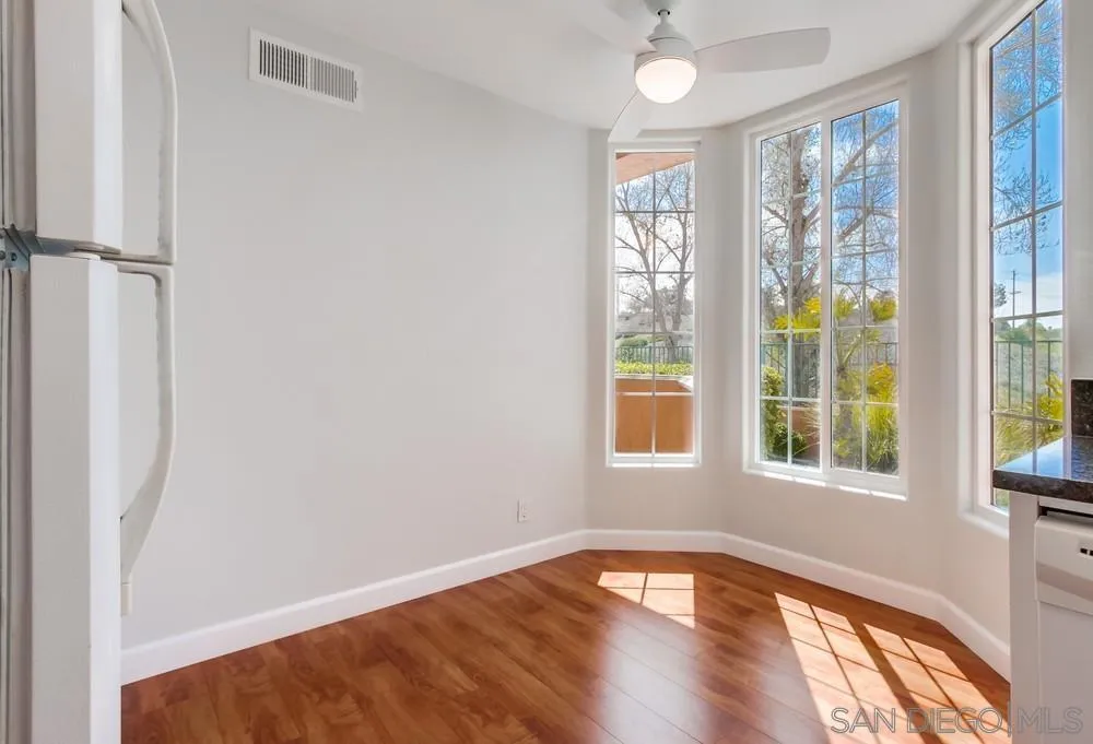 3525 Cameo Drive, Unit 92 Oceanside, CA 92056 - Photo 12 of 43 a view of an empty room with wooden floor and a window