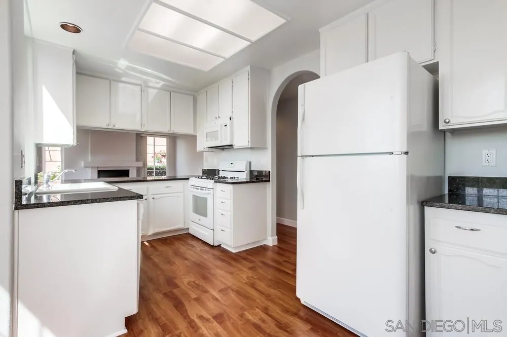 3525 Cameo Drive, Unit 92 Oceanside, CA 92056 - Photo 15 of 43 a kitchen with white cabinets and white appliances