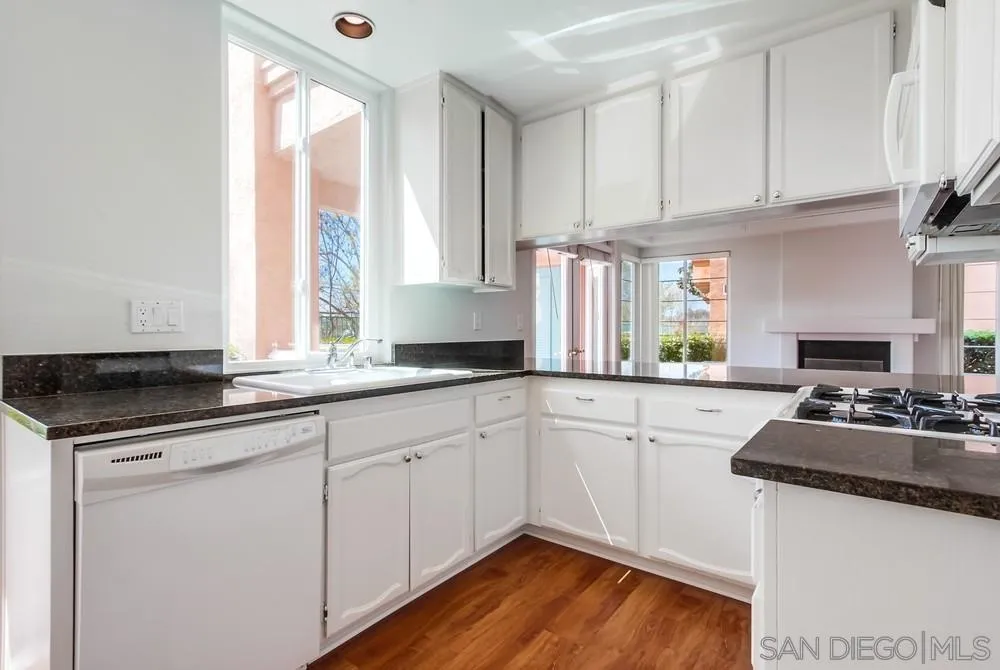 3525 Cameo Drive, Unit 92 Oceanside, CA 92056 - Photo 16 of 43 a kitchen with granite countertop white cabinets and a sink