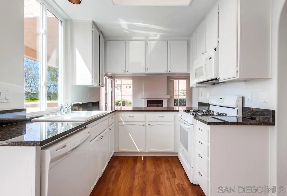 3525 Cameo Drive, Unit 92 Oceanside, CA 92056 - Photo 17 of 43 a kitchen with granite countertop cabinets stainless steel appliances a sink and a window