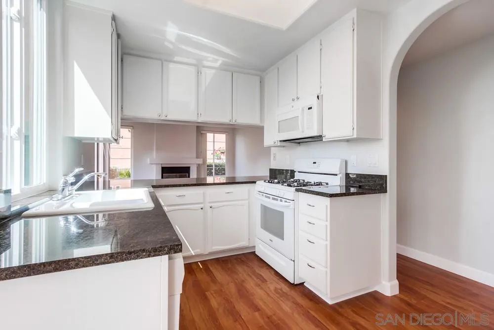 3525 Cameo Drive, Unit 92 Oceanside, CA 92056 - Photo 18 of 43 a kitchen with granite countertop white cabinets and white appliances