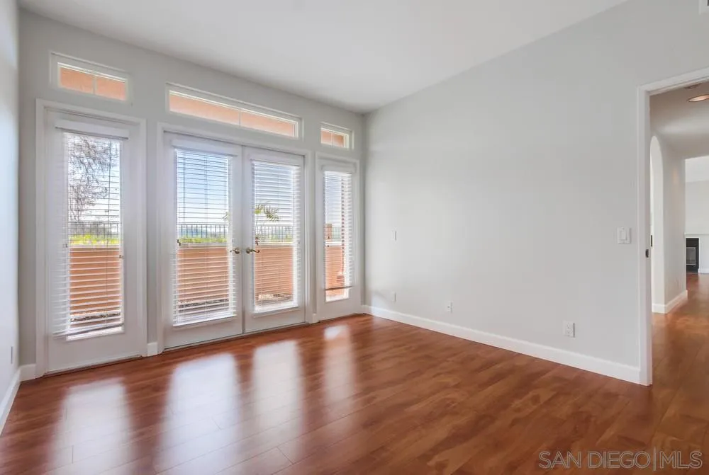 3525 Cameo Drive, Unit 92 Oceanside, CA 92056 - Photo 22 of 43 a view of an empty room with wooden floor and a window