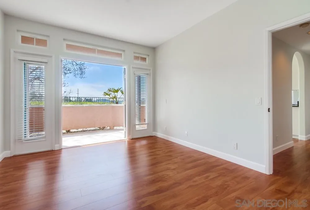 3525 Cameo Drive, Unit 92 Oceanside, CA 92056 - Photo 25 of 43 a view of an empty room with wooden floor and a window