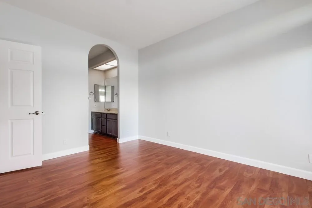 3525 Cameo Drive, Unit 92 Oceanside, CA 92056 - Photo 26 of 43 an empty room with wooden floor and windows