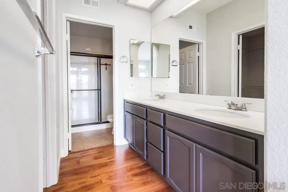 3525 Cameo Drive, Unit 92 Oceanside, CA 92056 - Photo 27 of 43 a bathroom with a double vanity sink and mirror