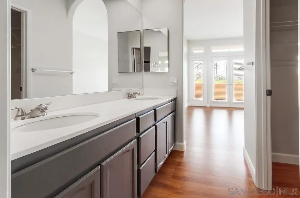 3525 Cameo Drive, Unit 92 Oceanside, CA 92056 - Photo 28 of 43 a bathroom with a sink a mirror and next to a window