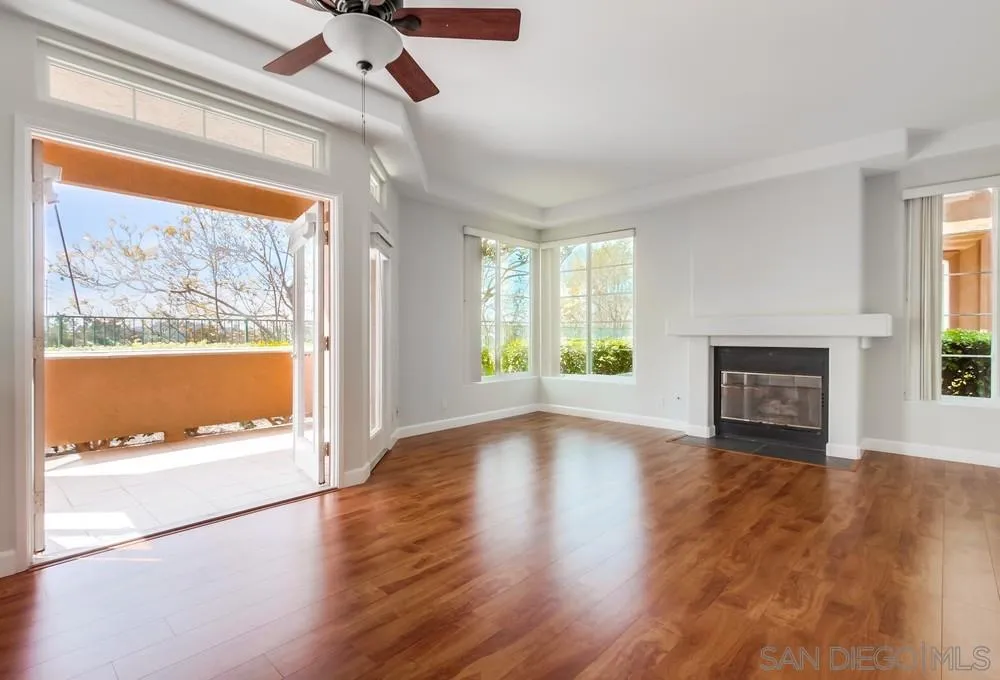3525 Cameo Drive, Unit 92 Oceanside, CA 92056 - Photo 4 of 43 a view of an empty room with wooden floor and a window