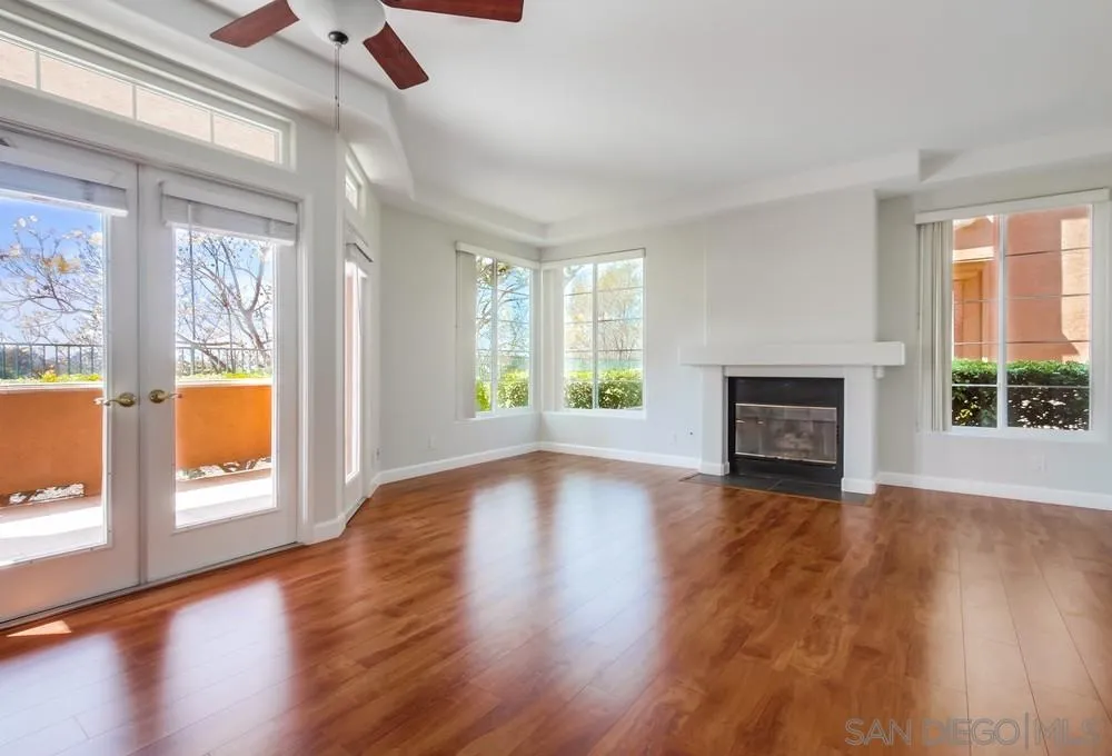 3525 Cameo Drive, Unit 92 Oceanside, CA 92056 - Photo 5 of 43 a view of empty room with wooden floor and fireplace