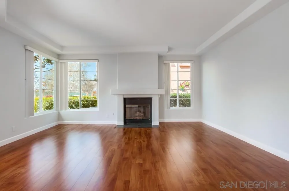 3525 Cameo Drive, Unit 92 Oceanside, CA 92056 - Photo 6 of 43 a view of an empty room with wooden floor and a window
